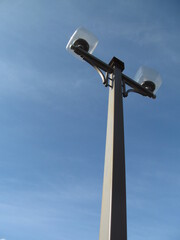 Lamp post with square diffusers on blue sky