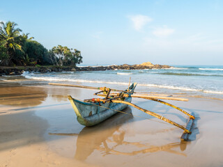Wooden fishing boat on the shore of the Indian ocean on the island of Sri Lanka