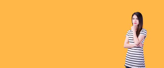 Portrait of beautiful asian young woman, on yellow  color background with copy space. Human face...