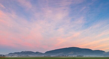 Beautiful pink sunrise over farm land