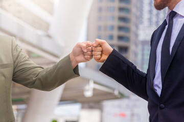 Corporate Celebration victory, Success and Winning Concept - Cropped image of Two business man use hand to fist bump for success teamwork coporate.