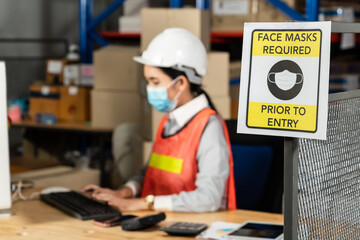 Caution sign in factory warning to industry labor worker to prevent Covid-19 Coronavirus spreading...