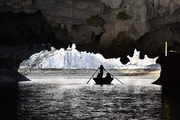 Local Rowboat Operator in Silhouette in Cave, Lan Ha Bay, Vietnam