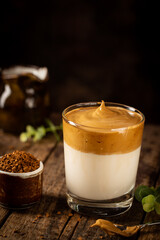 Dalgona Coffee, a cool fluffy whipped coffee in a glass. Latte espresso with coffee foam in tall glass. Trendy drink