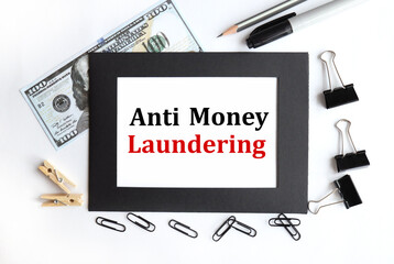 anti money laundering. AML.TEXT ON WHITE PAPER with black frame