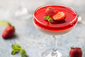 Italian panna cotta dessert with strawberry sirup and mint leaf