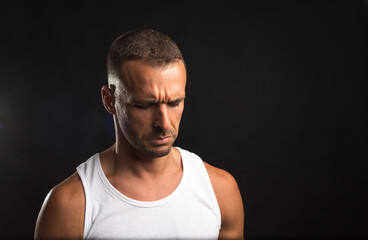 Fototapeta premium Sad athlete man in tank top.