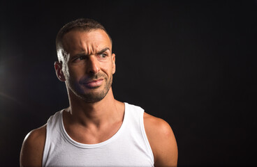 Fototapeta premium Distrustful athlete man in tank top.