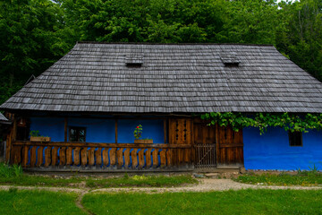 Fototapeta na wymiar peasant house with thatched roof and tile built of clay and brick
