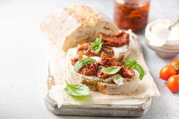 Bruschetta with sundried tomatoes, cottage cheese and fresh basil. Tasty savory Italian appetizers