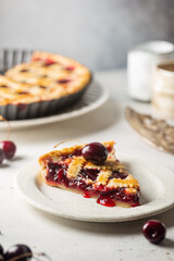 piece of Delicious homemade classic cherry pie with a flaky crust on white background