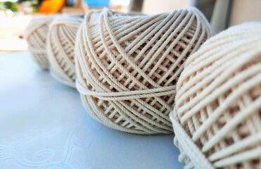 Obraz premium Soft white cotton thread roll with selective focus
