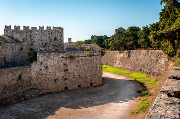Fototapeta na wymiar The medieval moat and the city walls. Rhodes island, Greece.