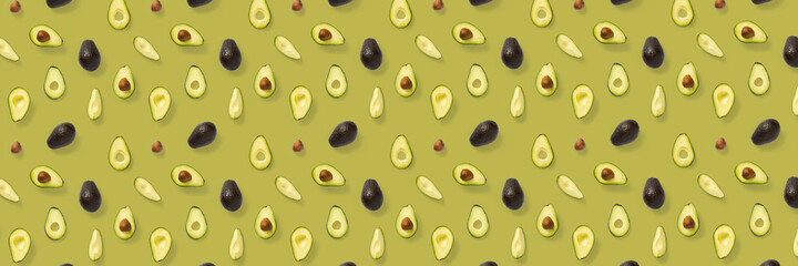 Avocado banner. Background made from isolated Avocado pieces on olive color background. Flat lay of fresh ripe avocados and avacado pieces.