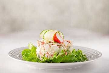 Salad of crab sticks, cucumbers, eggs and corn. Russian festive food