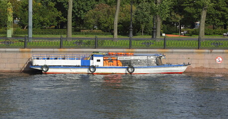 Obraz premium White tourist ship moored to the wall of the city embankment, Kronvergsky Strait embankment, Saint Petersburg, Russia, September 2020