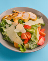 Bowl of Caesar salad. Traditional Italian cuisine concept, delicious and healthy meal.