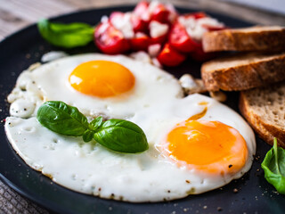 Continental breakfast - sunny side up eggs, toasts and vegetable salad
