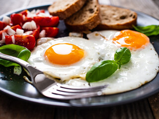 Continental breakfast - sunny side up eggs, toasts and vegetable salad
