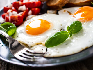 Continental breakfast - sunny side up eggs, toasts and vegetable salad
