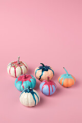 Autumn layout made of pumpkins with dripping color on pink background. Minimal Fall or Halloween concept.