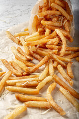 French fries with salt and cream cheese with sauce on the table. French fries sprinkled with salt. French fries with ketchup.