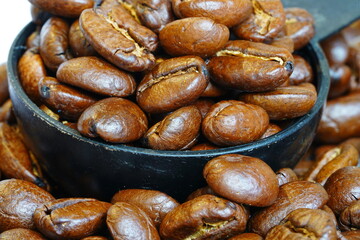 Close-up of coffee beans in a black cup
