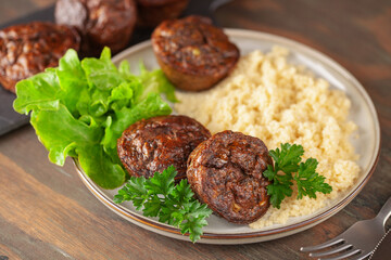 Healthy lunch - chicken liver maffins with salad and couscous on the table