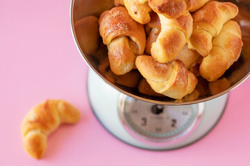 Sweet bread croissants arranged in a measuring scale