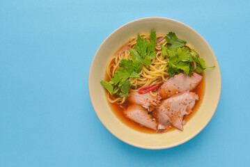 Japanese noodles soup ramen with meat and fresh organic greenery. Japanese cuisine concept.