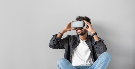 Handsome young man using virtual reality headset panoramic banner, VR, future, gadgets, technology concept