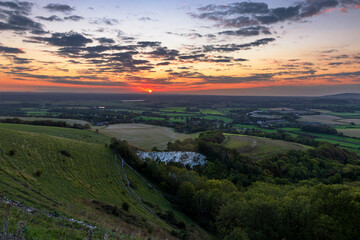 New dawn sunrise over the east sussex countryside and south downs, view from the top of Mount Caburn on the Lewes Downs south east England