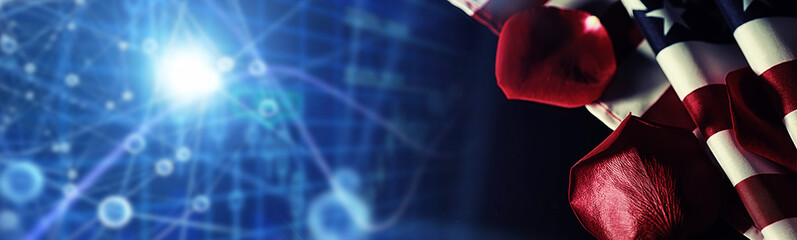 American flag and rose flower on the table. Symbol of the United States of America and red petals. Patriotism and memory.