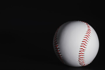 American traditional sports game. Baseball. Concept. Baseball ball and bats on a black table.