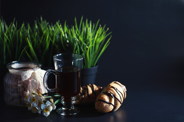 French breakfast on the table. Coffee croissant with chocolate and a decanter with cream. Fresh...