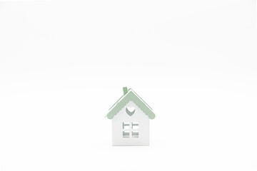 Small conceptual house isolated on white background with plenty of copy space.