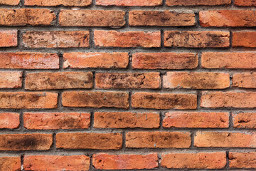Obraz premium A wall made of bricks, its surface looks rough