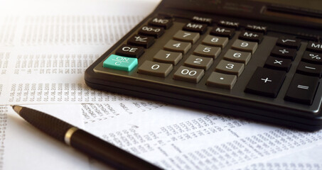 Business documents on an office desk with a calculator and pencil as a business concept of a workspace. With cloud exposure