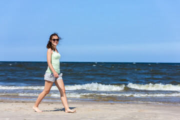 Fototapeta na wymiar Teenage girl walking on beach 