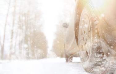 Car on a snowy winter road in fields.