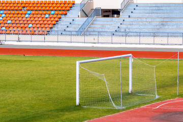 Football goals in a stadium with fresh green grass
