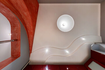 Stretch ceiling white and complex shape with halogen spots lamps and drywall construction in empty...