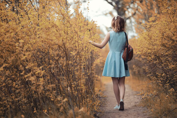 Young girl on a walk in the autumn