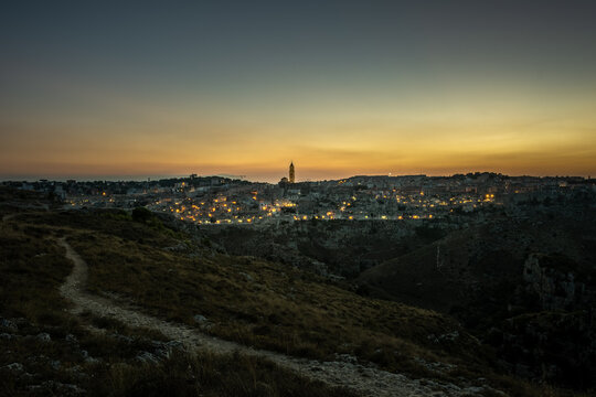 Panoramic view of the ancient city of Matera (Sassi di Matera) in the beautiful sunset light, blue hour, Basilicata, southern Italy