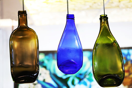 Colored, decorative bottles hang on a rope. Interior Design. Close-up.