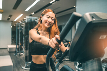 Fototapeta na wymiar Muscular asian young woman with beautiful body doing exercises . Sporty girl lifting weights in gym.