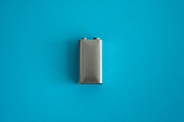 High voltage battery on a blue background. Silver Volt battery. 9V Advanced Lithium Batteries.