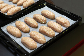 Cutlets. Cooking meat products at home. Baking tray with many meatballs before baking.