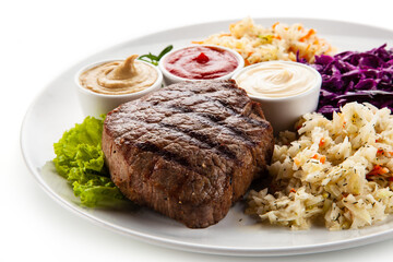 Barbecue beef steak with mix salad, mustard,  mayonnaise and ketchup on white background
