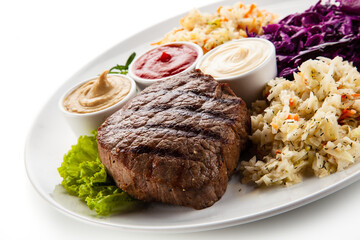 Barbecue beef steak with mix salad, mustard,  mayonnaise and ketchup on white background